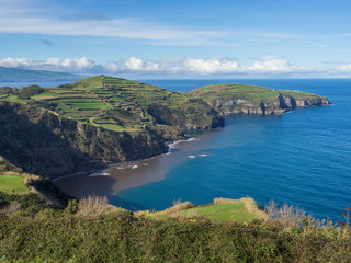 green fields pasture and coastal cliffs and blue ocean and sky horizon at north coast of sao miguel island, Azores, Portugal - Powered by Adobe