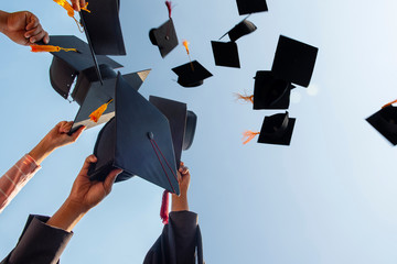 Black hat of the graduates floating in the sky. - obrazy, fototapety, plakaty