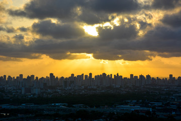 Fototapeta premium Aerial view of the historic city of Olinda in Pernambuco, Brazil at sunset contrasting with the contemporary skyscrapers of Recife in the far background