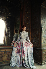 Obraz premium beautiful woman standing in the palace room with mirror. 