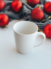 Obraz na płótnie Canvas Empty white mug on the background of christmas tree decorations