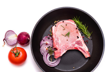 Raw pork meat. pork on the bone, steak, pieces of pork and vegetables in a pan. isolate on white background