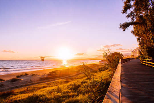 Sunset. Mediterranean Sea, beach and promenade of Marbella.
