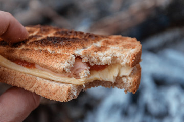 Bitten cake with cheese cooked on the fire.