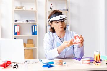 Female doctor working on new teeth implant 