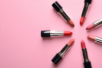 Flat lay composition with lipsticks and space for text on color background