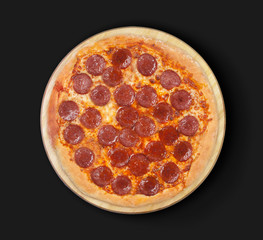 Isolated pizza pepperoni on a black  background.