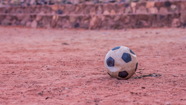 Deflated Ball On Desert Sand Slum Of Third World Concept Photography Wallpaper Pattern Background Concept With Empty Copy Space For Your Text Or Inscription