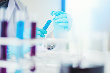 Scientist with equipment holding tools during scientific experiment science concept