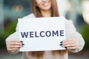 Women business with the poster with welcome message