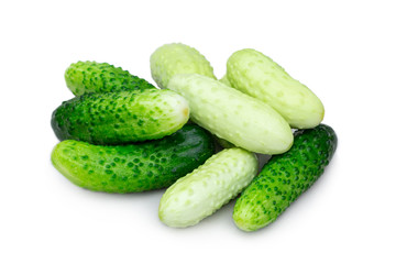 Several small cucumbers gherkins of different varieties isolated on white background