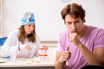 Young handsome man visiting young female doctor otolaryngologist