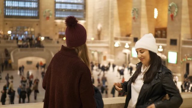 Two friends travel to New York for sightseeing and enjoy Grand Central Station