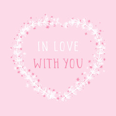 Vector hand drawn illustration of text IN LOVE WITH YOU and floral frame in the shape of a heart on pink background. 