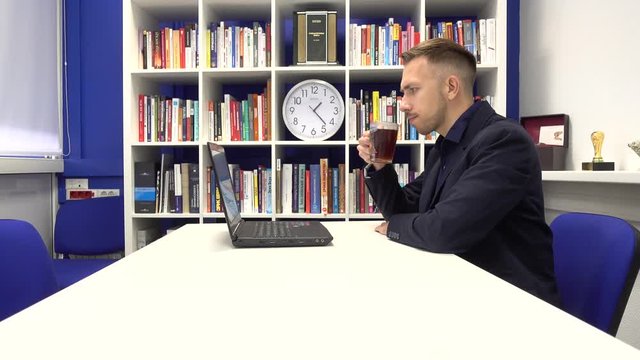 Businessman in the office drinking tea