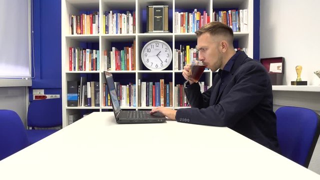 Businessman in the office drinking tea