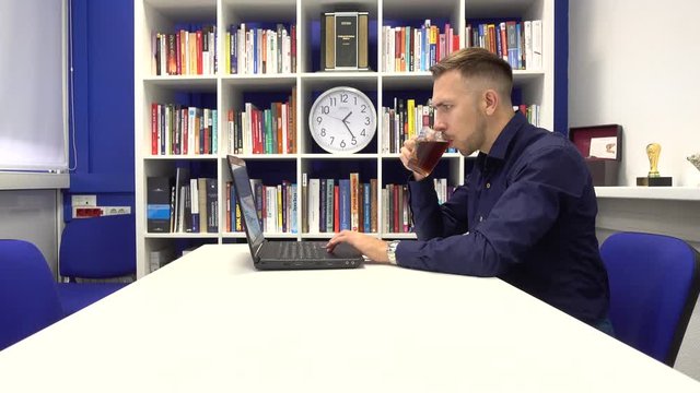 Businessman in the office drinking tea