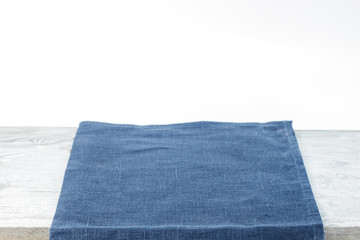 Empty plate on tablecloth on wooden table over grunge background