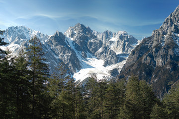 Jade dragon snow mountain situated in Yulong, Yunnan China.  The snow covered mountain with rocky...