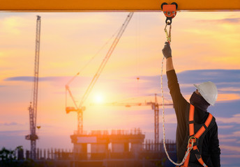 Construction worker wearing safety harness and safety line working high place at industrial. - 245844232