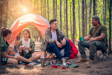 Young asian people hiking in the forest during summer at sunset,travel,tourism and teamwork concept