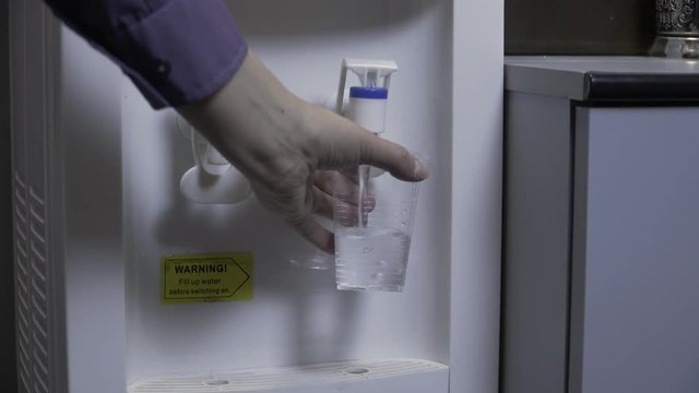 Cold water is poured from the cooler