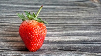 Fresh strawberry on wooden table.