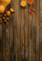 Kitchen table with pumpkin and spices. Space for text