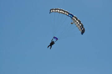 Two Men Skydiving with a Parachute