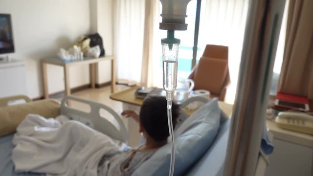 Little boy get sick from influenza need to be admitted to hospital with saline intravenous (iv)  in-line hand pressure