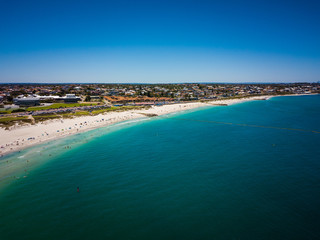 Fototapeta na wymiar Drone photo of beach and water in summer with people swimming, blue sky