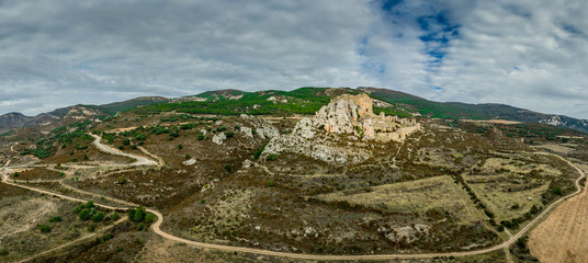 Aerial panorama view of medieval Romanesque partially restored Loarre castle near Huesca in Aragon province Spain surrounded by  fog and clouds