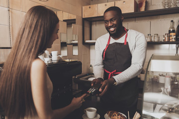 Young girl is calculated the cafe by credit card