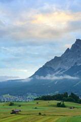 Summer of very large farm with the village and Mt. Zugspitze on the sunrise with fog , Ehrwald, Wetterstein mountain range at Biberwier, Tyrol, Austria 