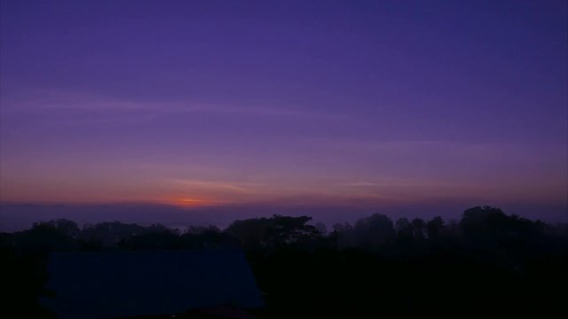 Winter sunrise in purple sky.