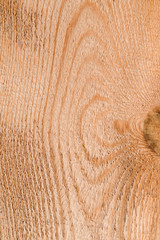 The texture of untreated coniferous wood with a beautiful organic pattern, background from pine boards
