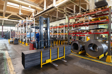 Factory stock wire. Wire spools lie on multi-tiered racks.