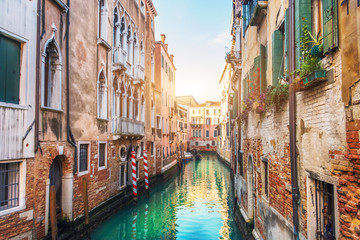 Narrow streets with canals and apartment buildings in Venice, Italy.