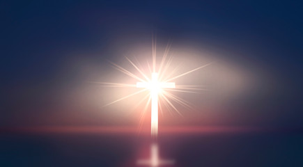 Concept of Jesus Christ: white cross on sunset sky background