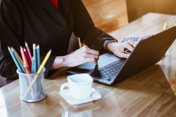 Business woman hands typing on the notebook keyboard at the table in office. Business technology concept