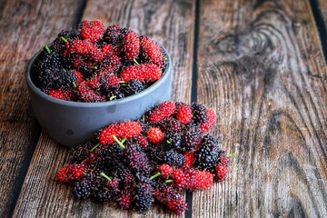 Close up of mulberry on wooden table