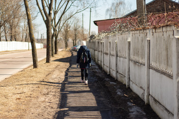 old white high concrete fence along the sidewalk