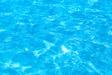 Fototapeta na wymiar Surface of blue clear swimming pool. Water background pattern for background.