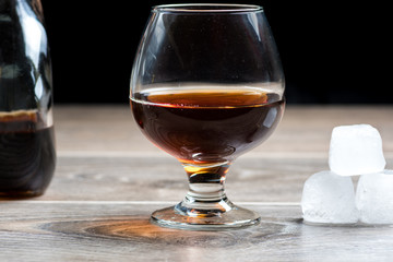 Brandy glass and falling ice splashes