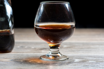 Brandy glass and falling ice splashes