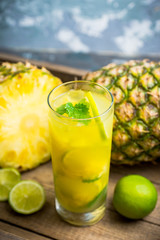 Fresh pineapple mojito on rustic background. Selective focus. Shallow depth of field.