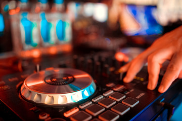 Fototapeta na wymiar Dj mixes the track in the nightclub at party.