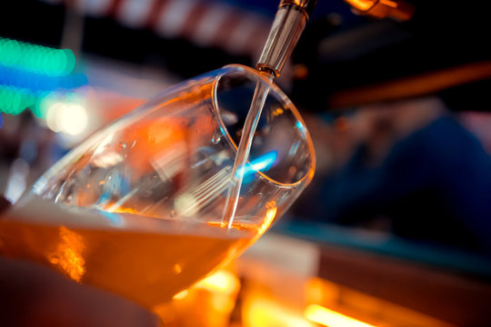 Close-up Of Barman Hand At Beer Tap Pouring A Draught Lager Beer