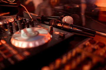 Dj mixes the track in the nightclub at party.