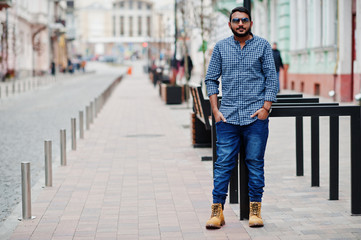 Stylish indian beard model man in casual clothes posed outdoor at street of India.